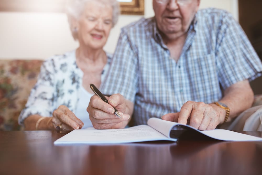 senior-couple-signing-documents